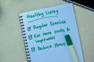 Concept of Healthy Living write on book with keywords isolated on Wooden Table.