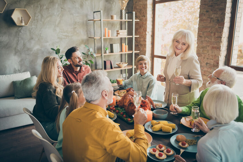 Family celebrating thanksgiving together at dinner table