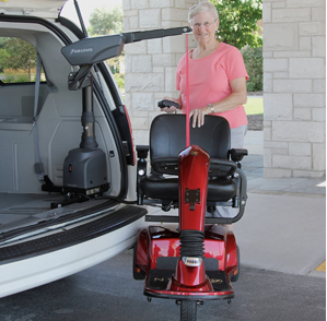 Woman utilizing her vehicle modification lift for her wheelchair outside