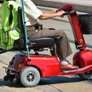 Old man with an electric wheelchair on the street