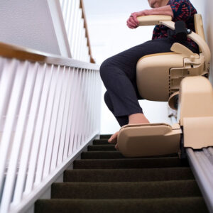 woman riding down home Stairlift