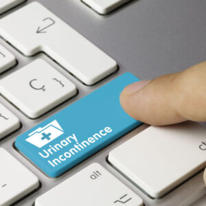 Urinary Incontinence Written on Blue Key of Metallic Keyboard. Finger pressing key.